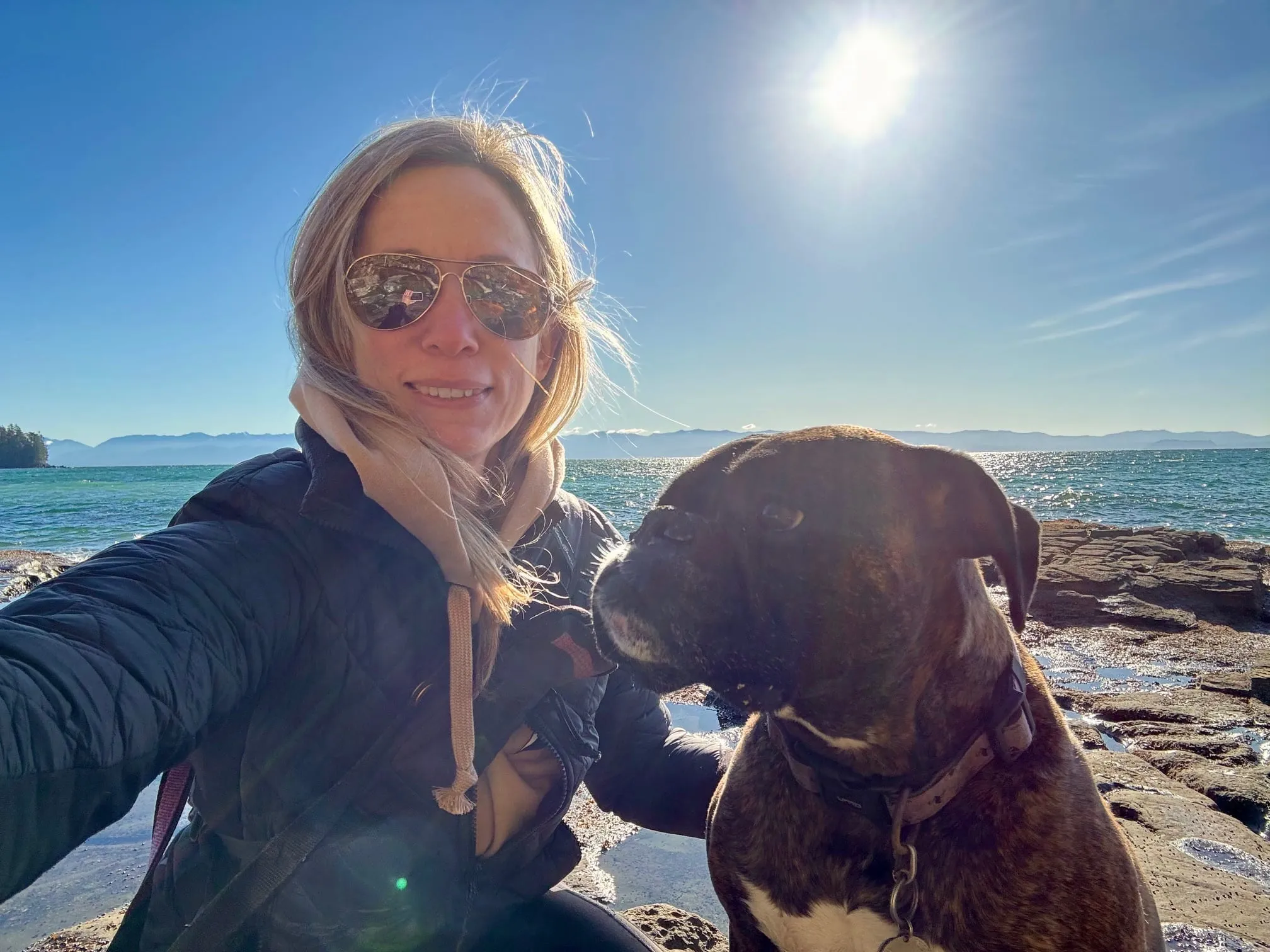 Sara Mariuz on a sunny beach with her dog.